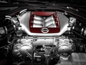 Close-up of a modern car engine with polished components and intake manifold.