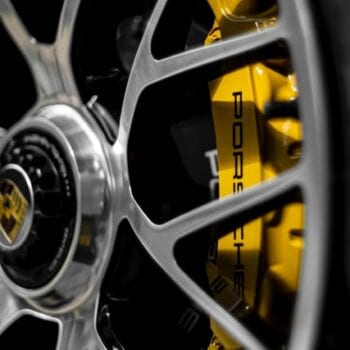 Close-up of Porsche brake caliper and wheel rim.