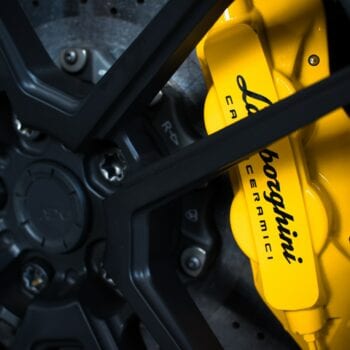 Close-up of yellow Bolognese brake caliper on a sports car.