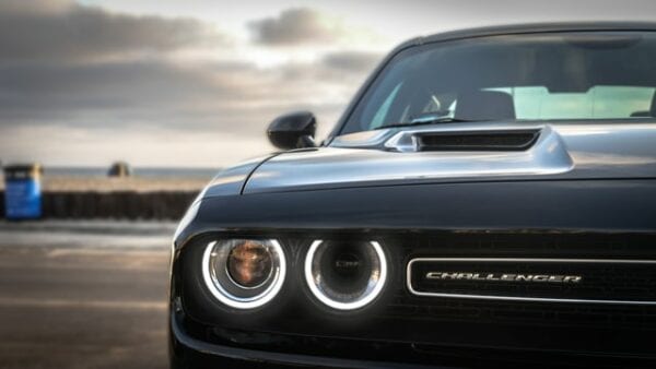 Close-up of a Dodge Challenger front view at Techline Motors shop.