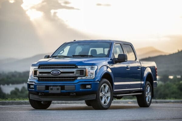 Blue Ford pickup truck parked outdoors during sunset in Kitchener.