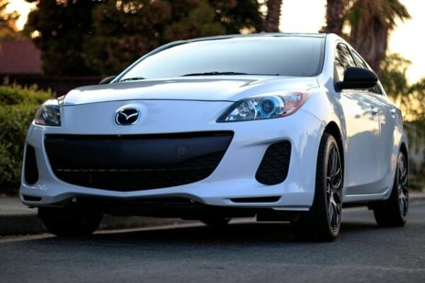 White Mazda car parked outdoors in Kitchener area.