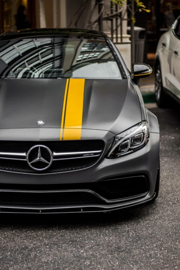 Gray Mercedes sports car with yellow stripe at Techline Motors.