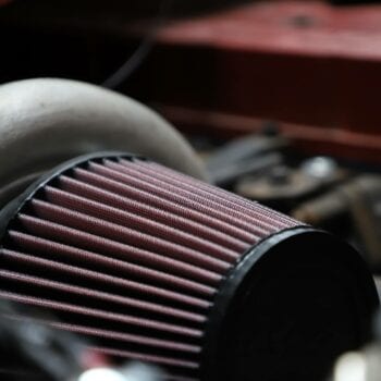 Close-up of a car air filter in an engine bay at Techline Motors.