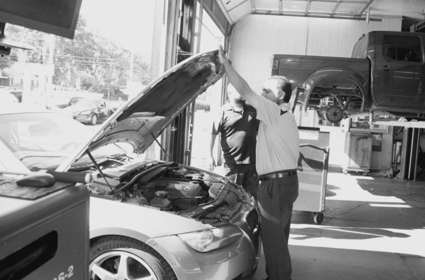 Skilled mechanic inspecting car engine during repair at Telegraph Auto Repair.