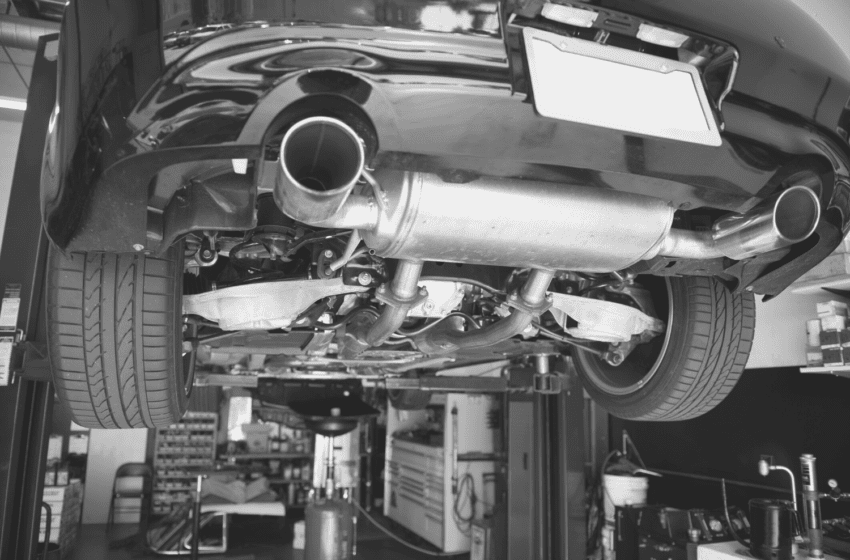 Close-up of a car's exhaust system during repair at Telegraph Auto Repair.