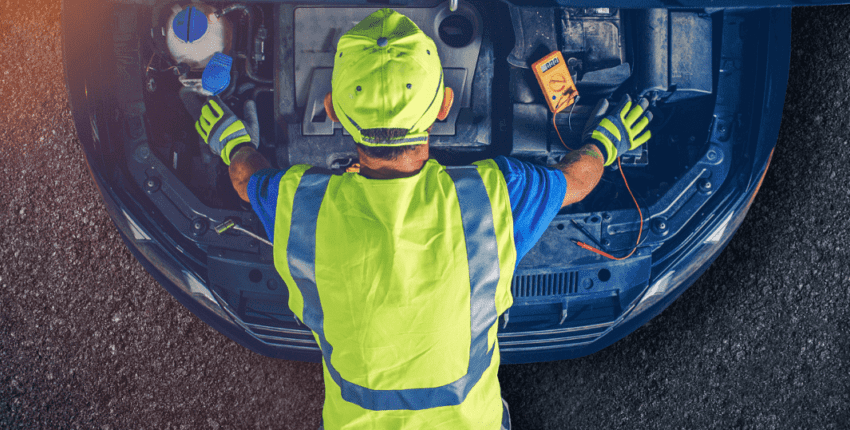Auto electrical repair technician working on vehicle in Alexandria, VA.