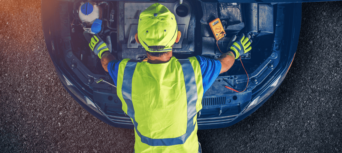 Auto electrical repair technician working on vehicle in Alexandria, VA.