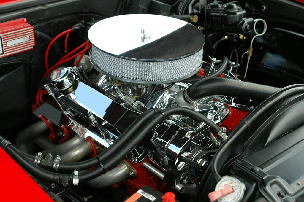 Engine bay with upgraded performance parts and chrome details.