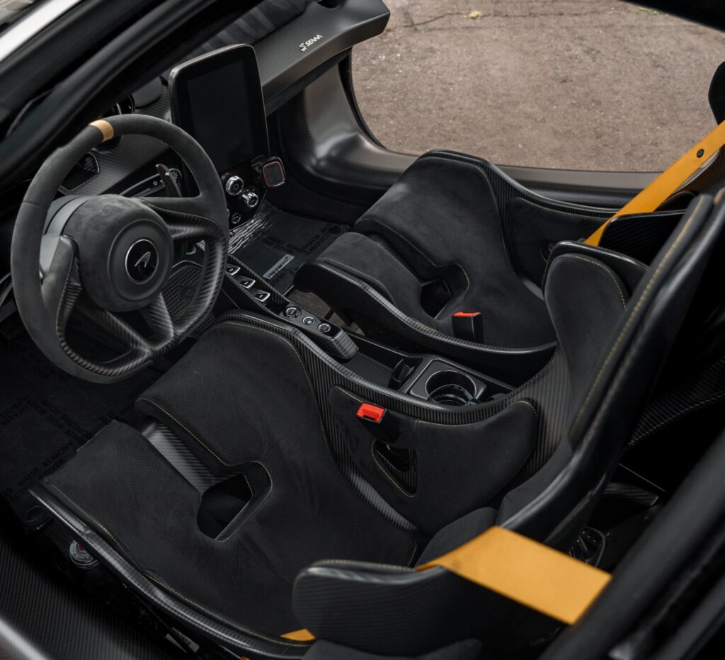Luxury racing car cockpit with racing seats and advanced dashboard.
