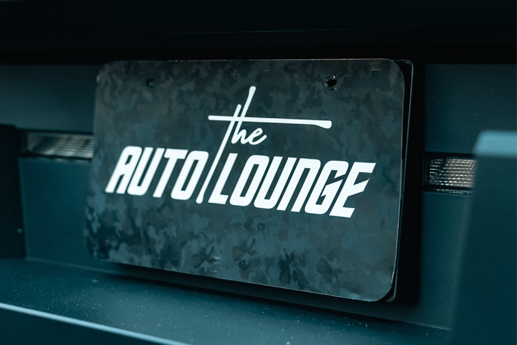 Auto Lounge logo on a stylish signboard.