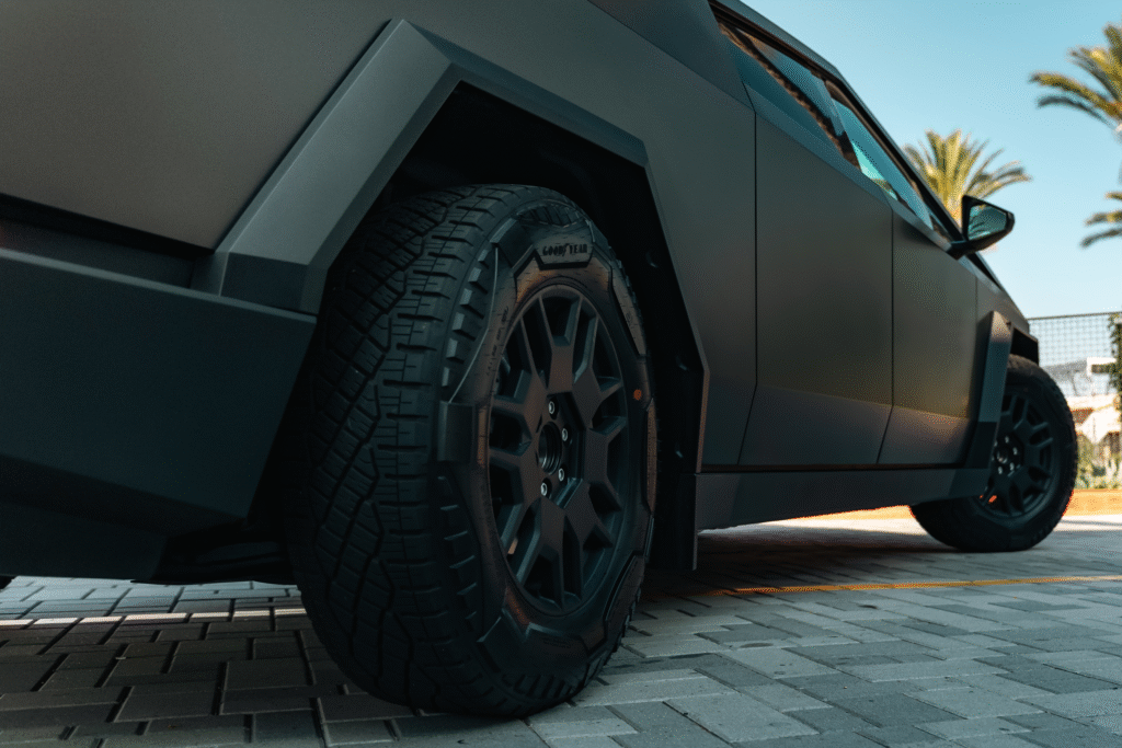 Luxury matte black SUV with off-road tires at The Auto Lounge.