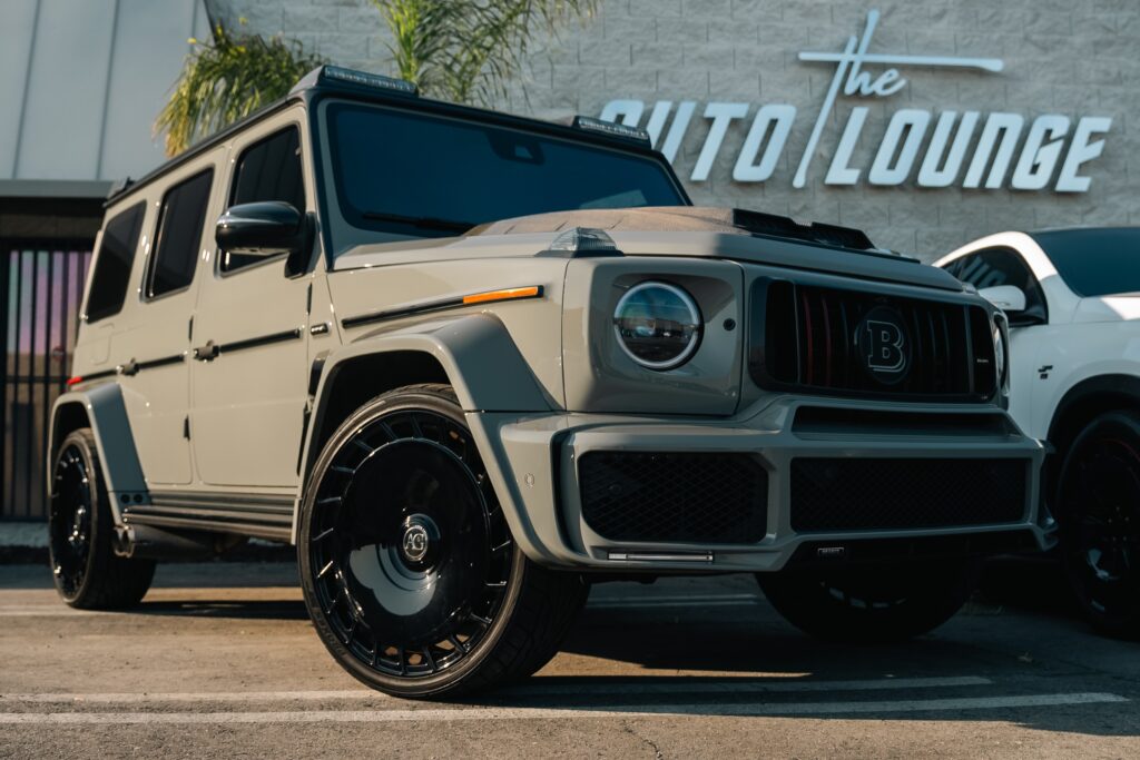 Mercedes-Benz G-Class SUV with sleek design and black custom wheels.