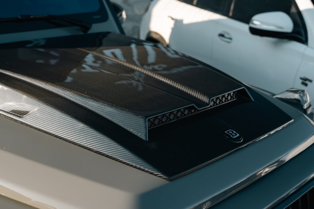High-quality carbon fiber hood with sleek design and aerodynamic features.