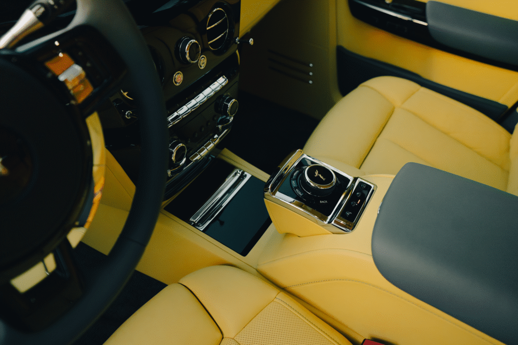 Luxury yellow car interior with premium leather seats and advanced controls at The Auto Lounge.