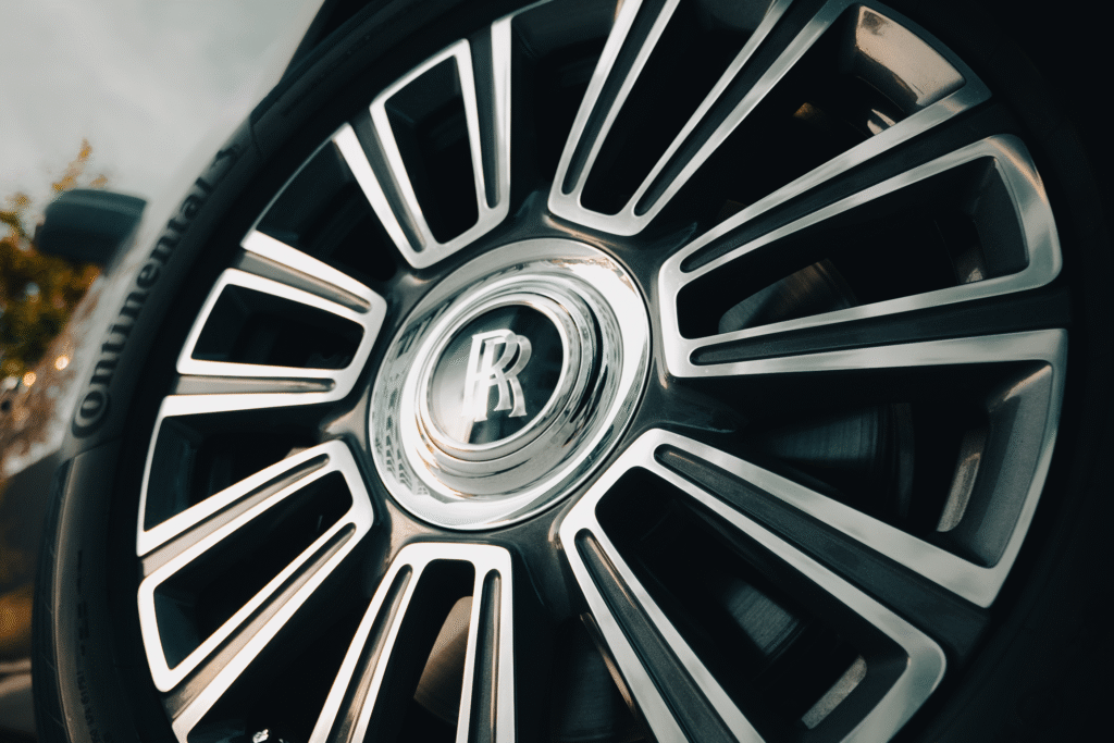Luxury car wheel with Rolls-Royce emblem at The Auto Lounge.