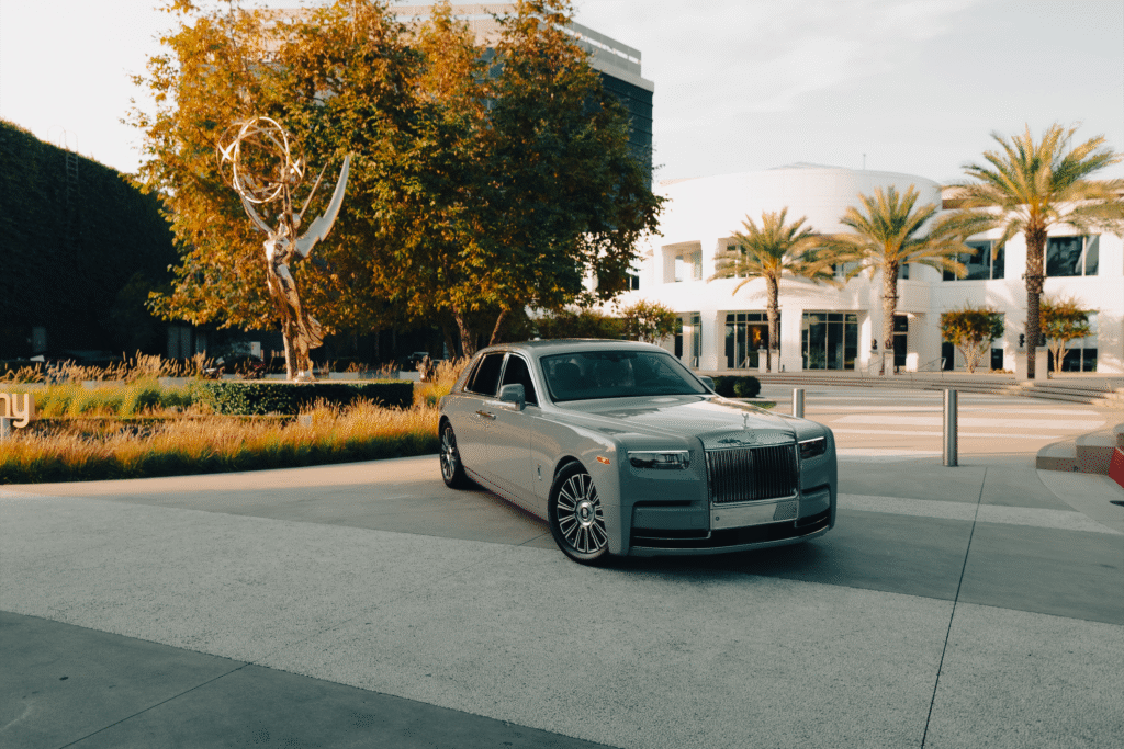Elegant black luxury sedan parked outside The Auto Lounge showroom, showcasing premium vehicle optio.