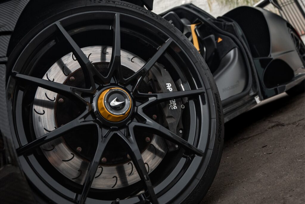 Close-up of a sleek electric car wheel with advanced braking system.