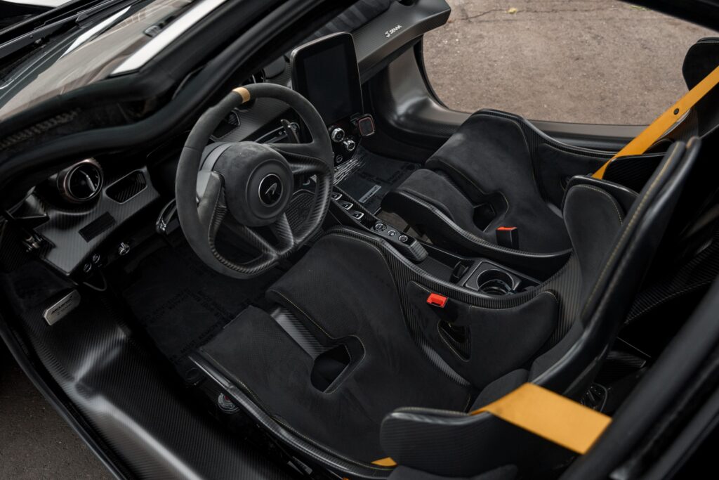 Interior of a high-performance sports car with racing seats and advanced dashboard.