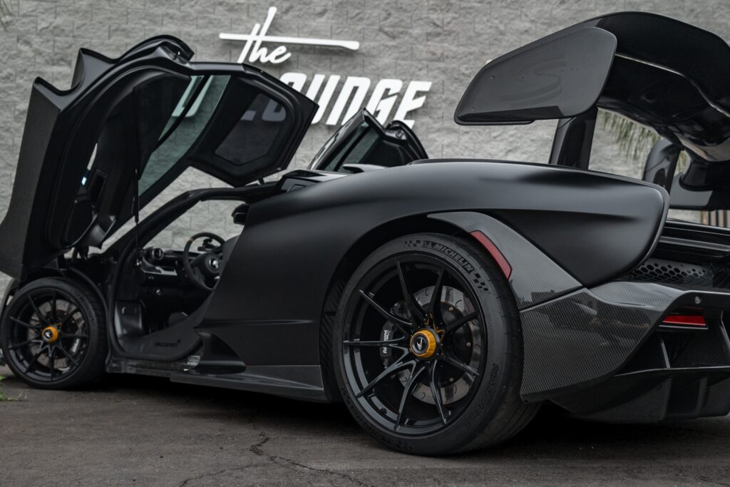 Black Lamborghini Aventador Roadster with open doors at The Auto Lounge.
