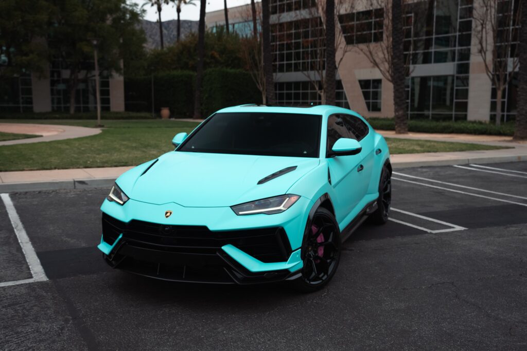 Blue Lamborghini Huracán parked in an outdoor lot, showcasing luxury sports car design.