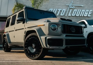 Luxury SUV parked outside The Auto Lounge dealership.