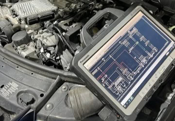 Diagnostic scanner on car engine for auto repair.