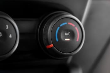 Car air conditioning control knob with temperature and A/C settings.