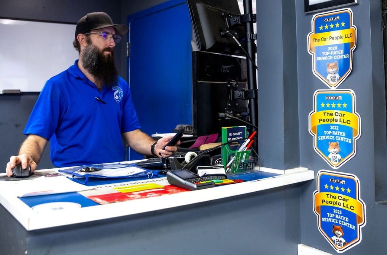 Automotive service advisor at the reception desk of The Car People LLC.