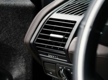 Air conditioning vent in a vehicle interior for climate control.