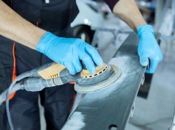 Surface polishing with professional tools and blue gloves for a smooth finish.