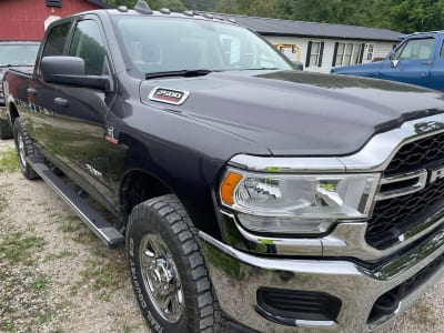 Black Ram 1500 pickup truck parked outdoors with a modern design.