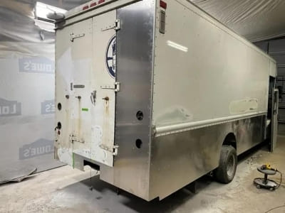 Food truck with stainless steel exterior for mobile catering and food delivery.
