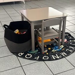 Child-friendly car service waiting area with small table and toy storage for kids at The Simple Auto.