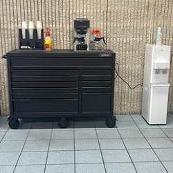 Professional auto shop workbench with tools and equipment for vehicle maintenance.