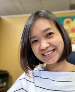 Woman smiling at Thrive Naturopathic clinic, promoting wellness and natural health.