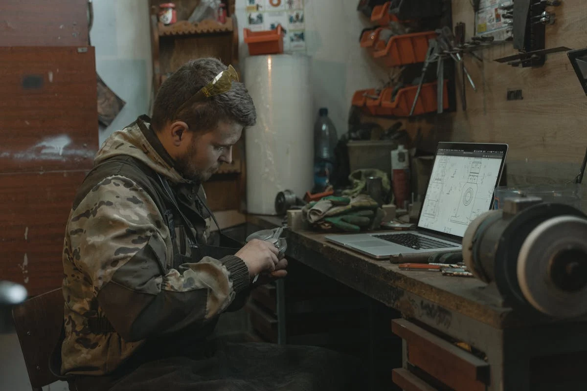 Vehicle electronics technician diagnosing a car module at Tools in Motion.