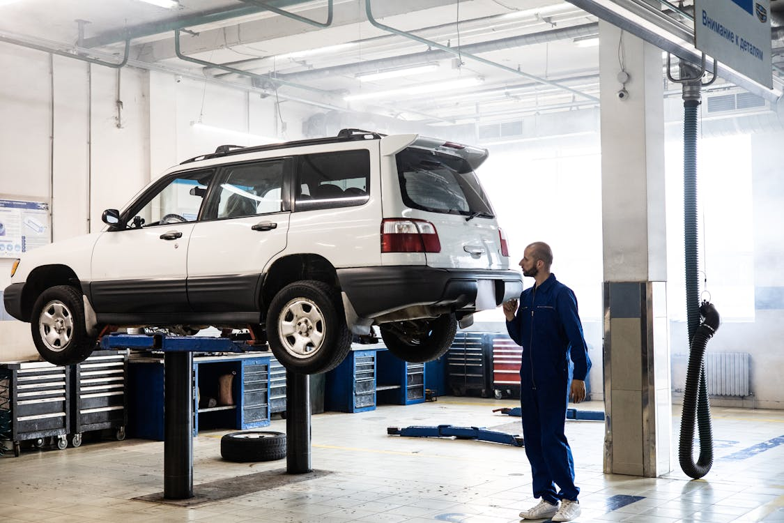 Auto diagnostics in progress with vehicle elevated for thorough inspection.