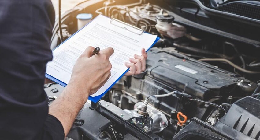 Auto maintenance technician checking engine condition.
