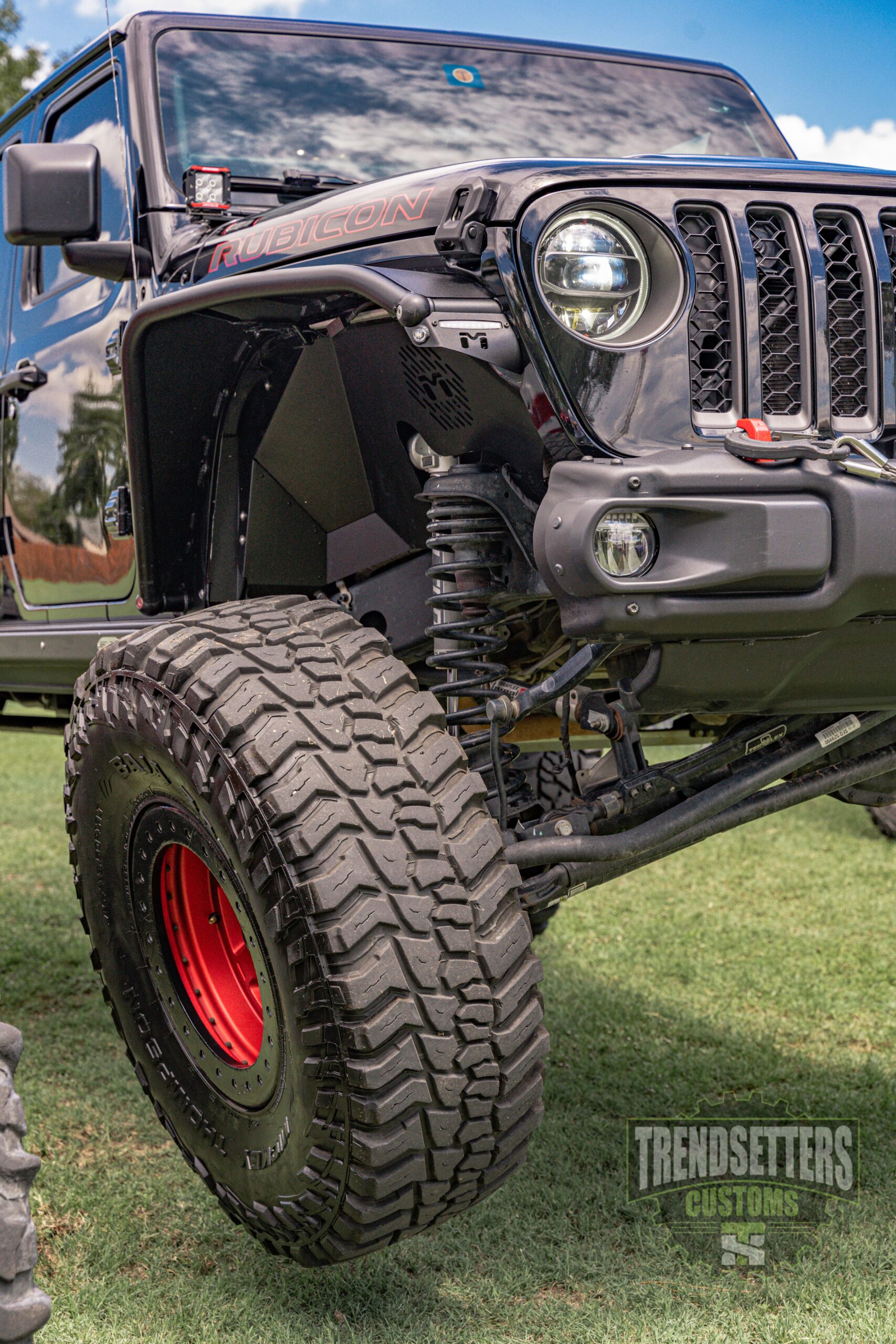 Jeep Wrangler with custom off-road modifications and large tires.