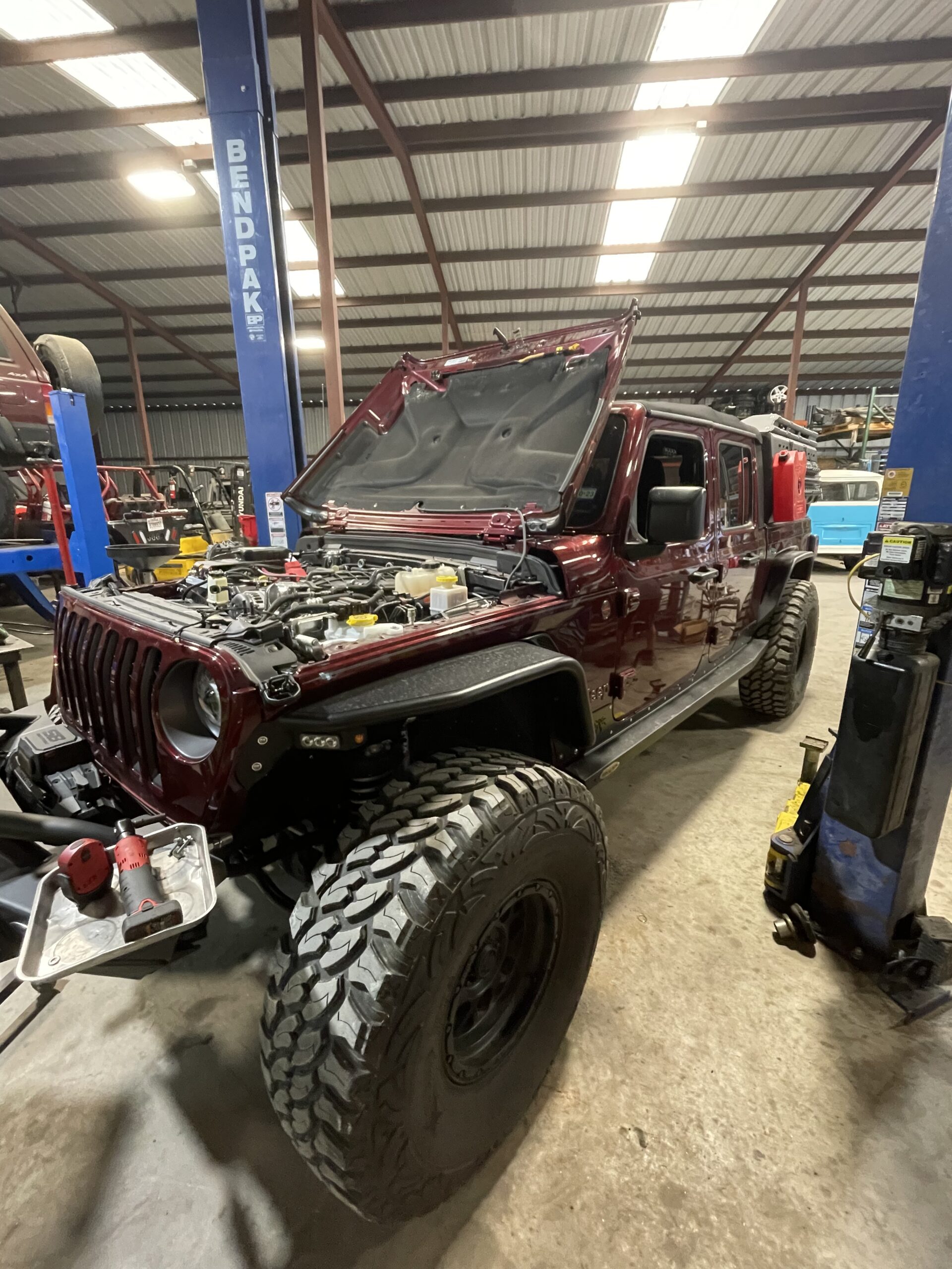 Custom Jeep Wrangler with lifted suspension and off-road tires.