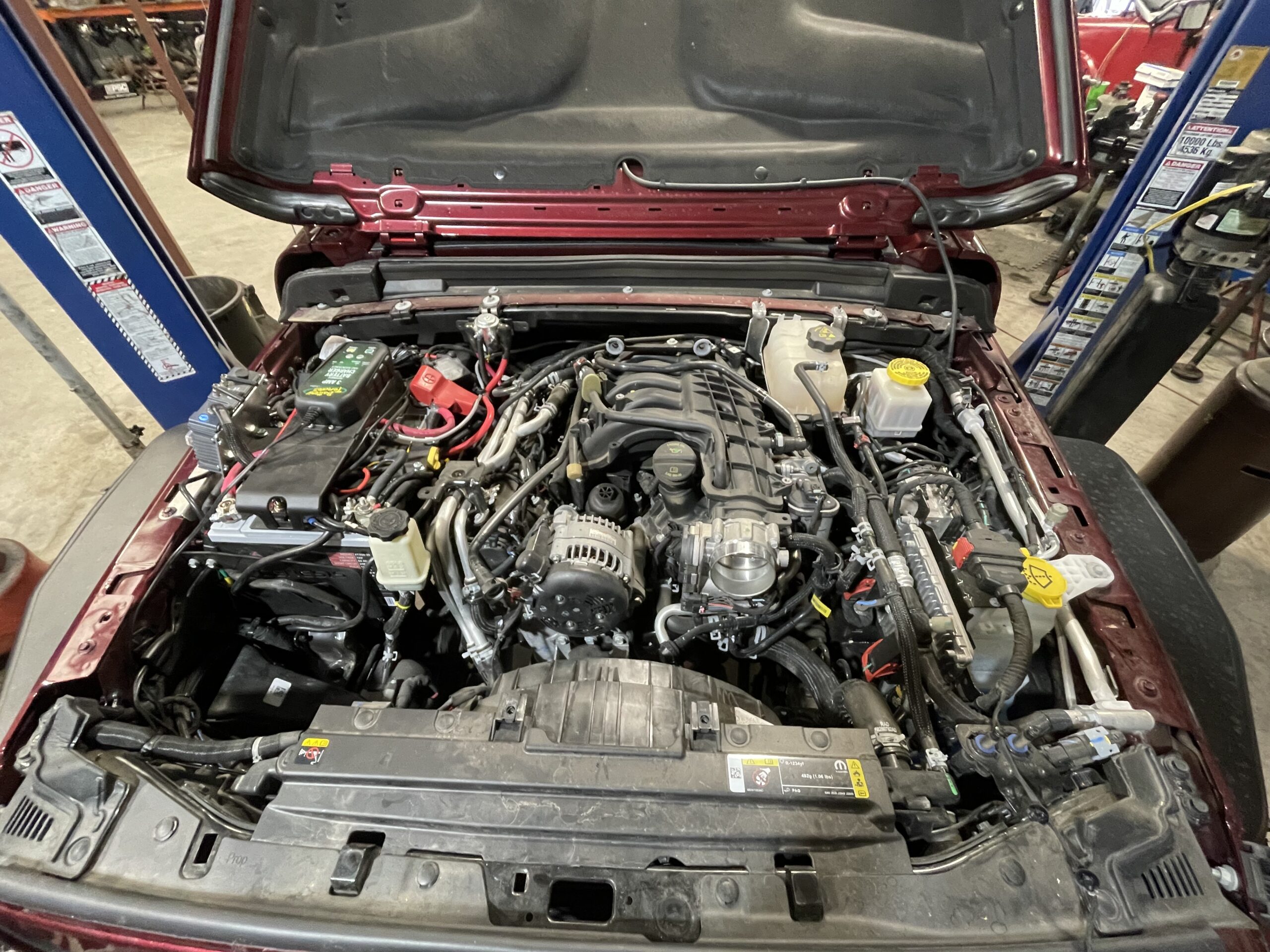 Engine bay of a customized vehicle with performance modifications.