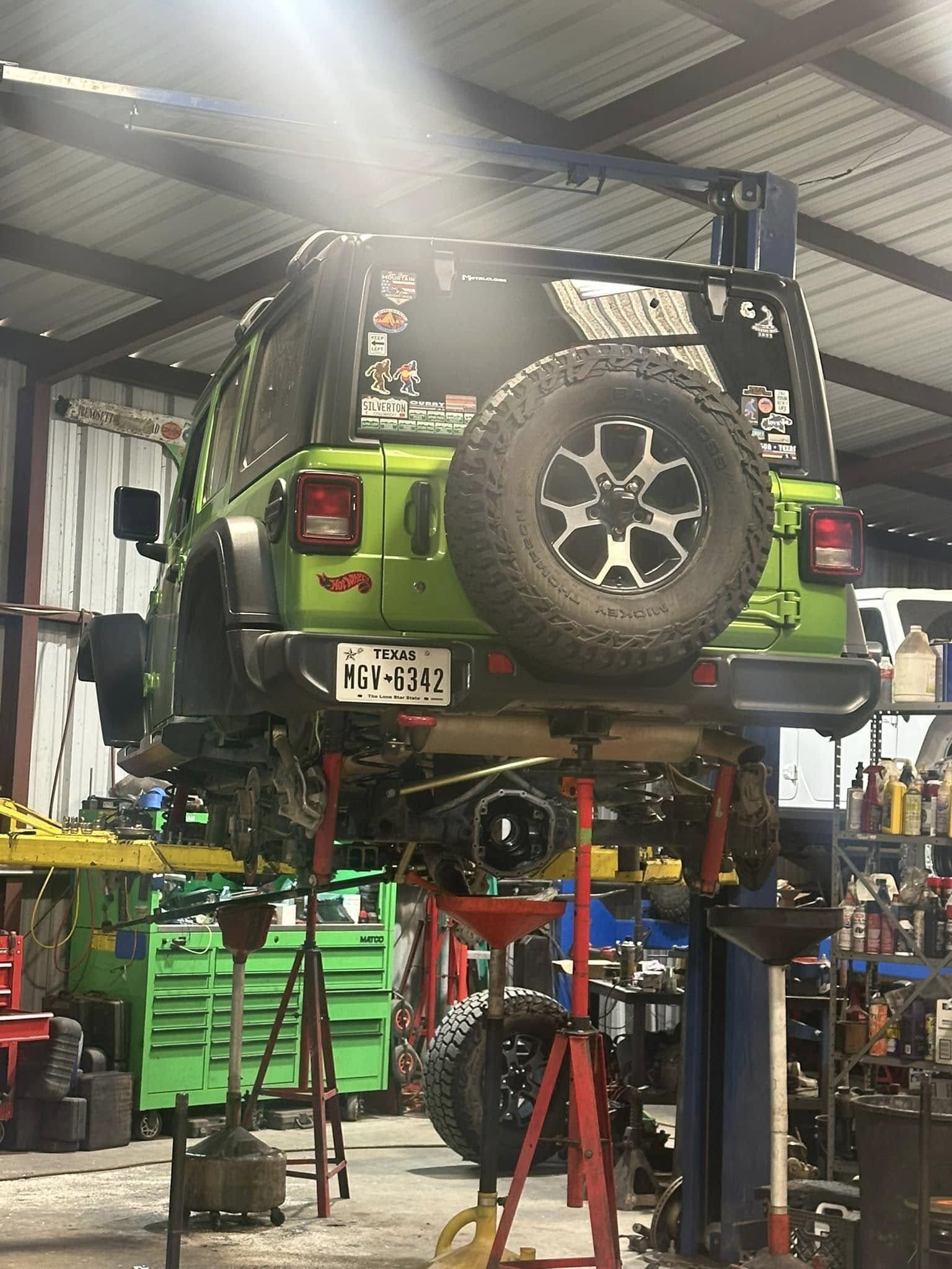 Jeep Wrangler lifted for off-road adventures, showcasing custom modifications and rugged tires.