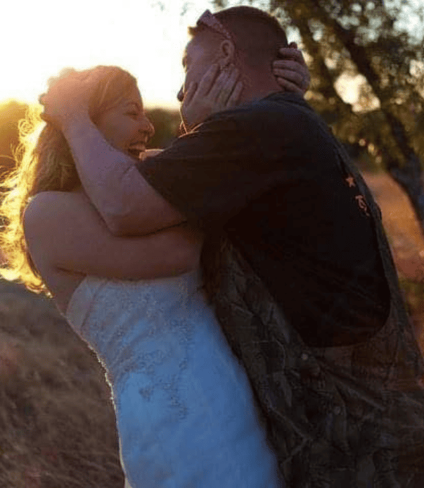 Happy couple embracing, showcasing love and connection in a natural setting.