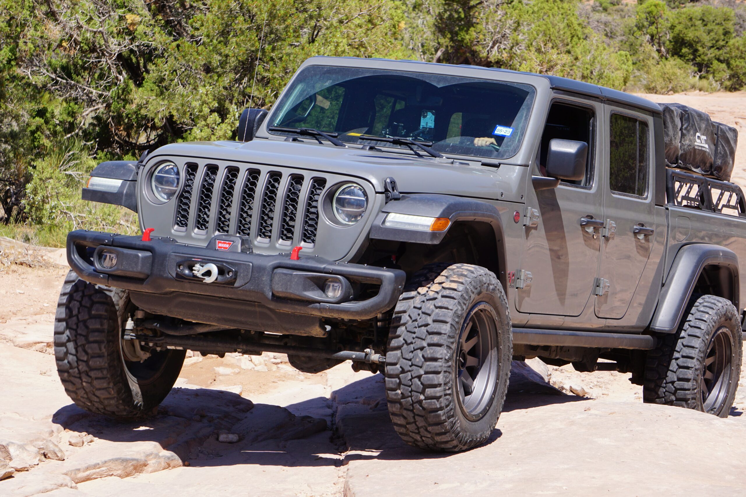 Off-road Jeep Wrangler with custom wheels and rugged tires for outdoor adventures.