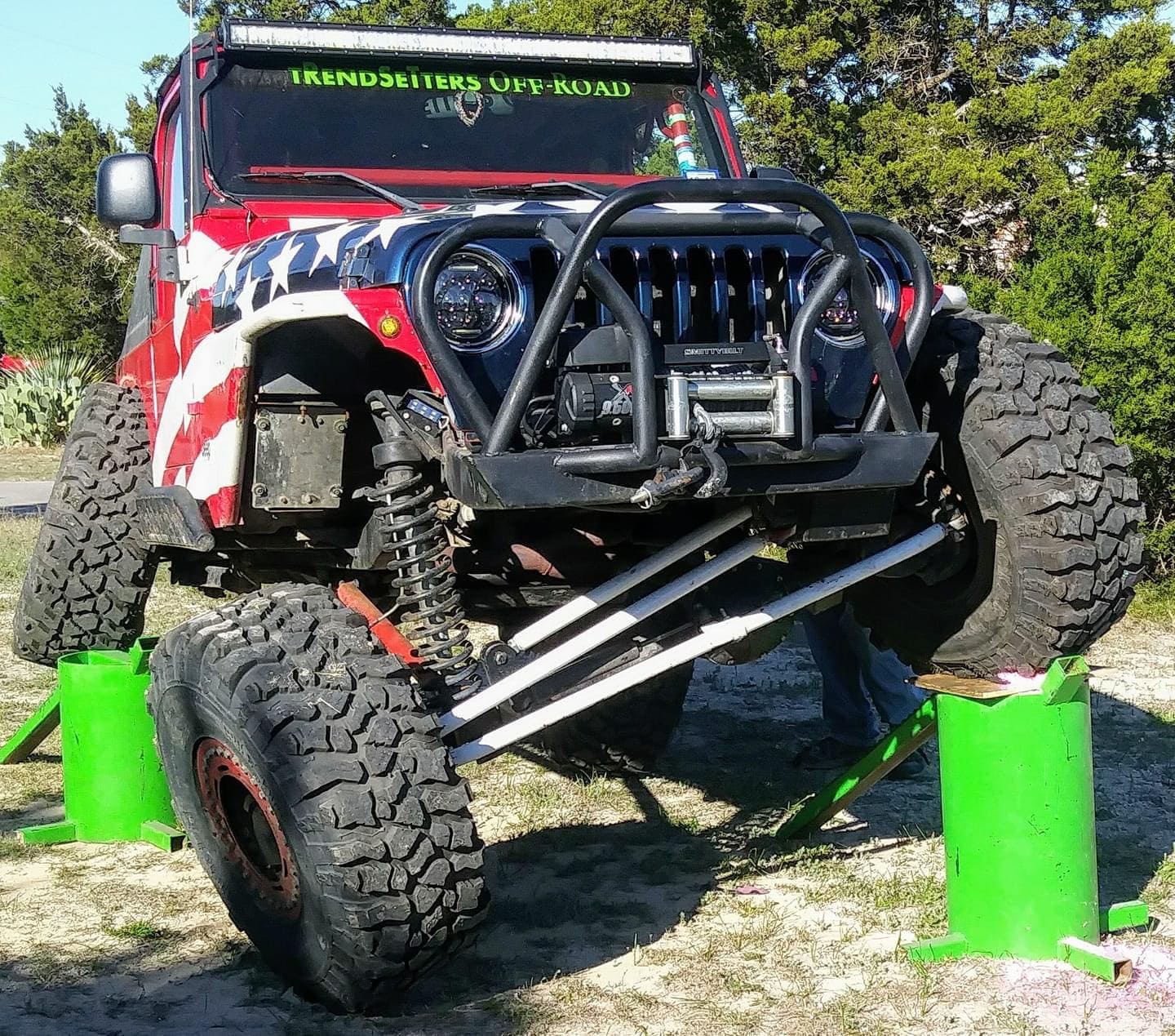 Off-road Jeep with custom suspension and bold paint job, designed for rugged terrain and adventure.