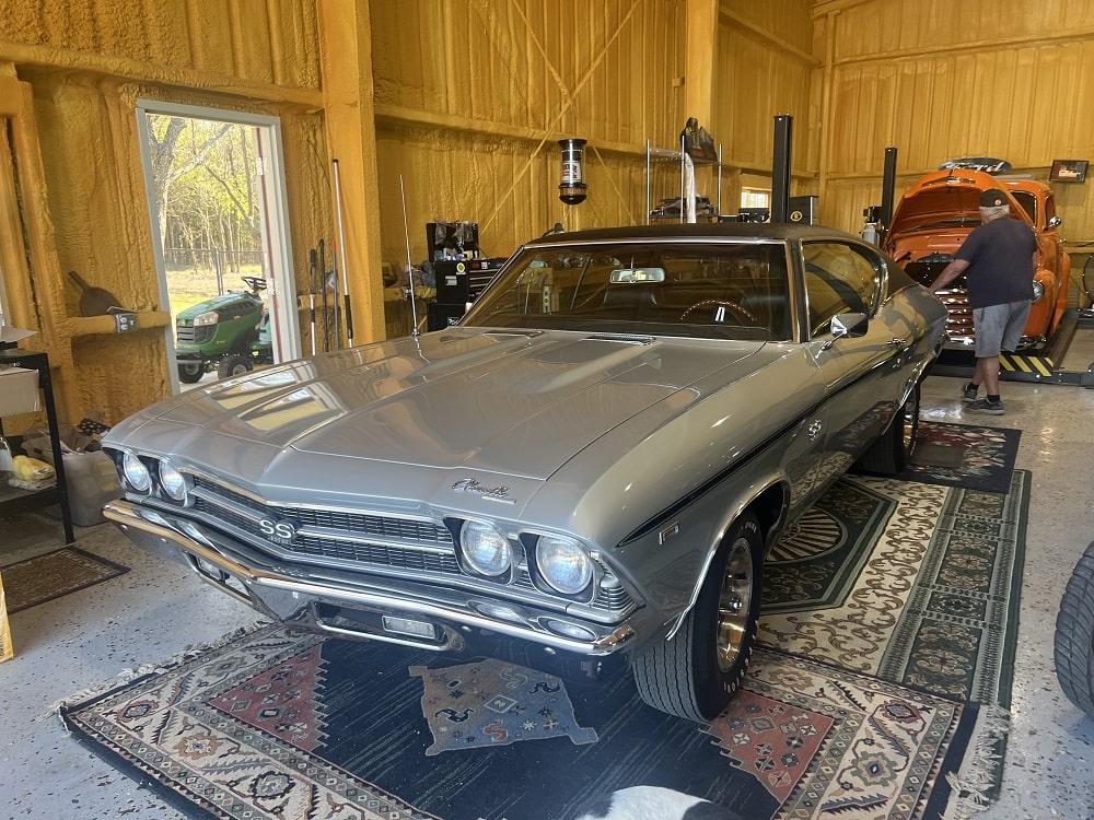 Vintage Chevrolet Chevelle SS muscle car in a well-lit garage interior.