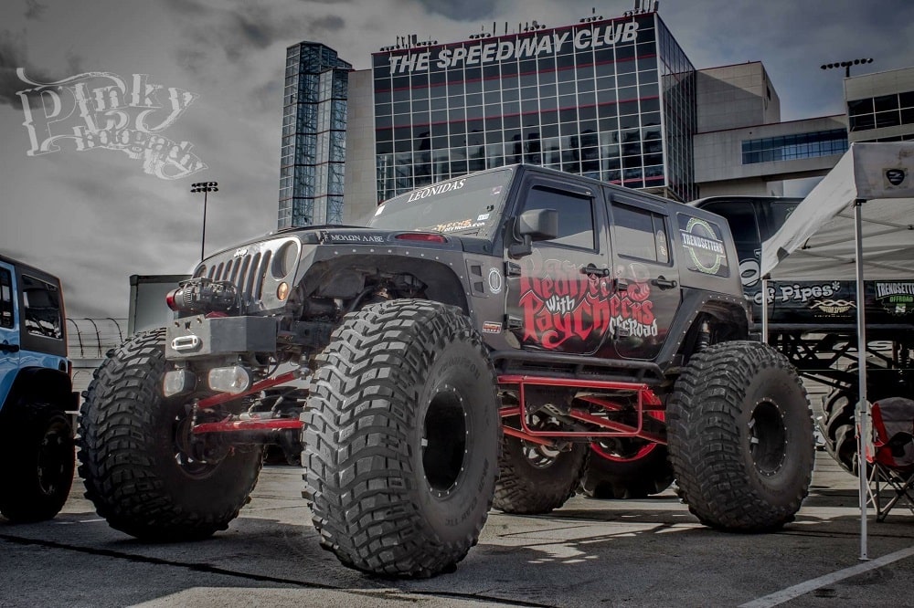 Highly customized off-road Jeep with oversized tires and bold graphics. Perfect for off-road adventu.