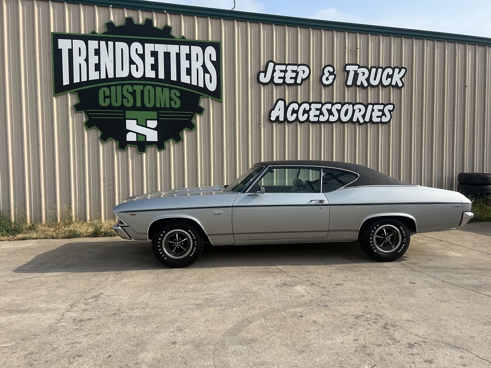 Classic car parked outside Trendsetters Customs specializing in Jeep and truck accessories.