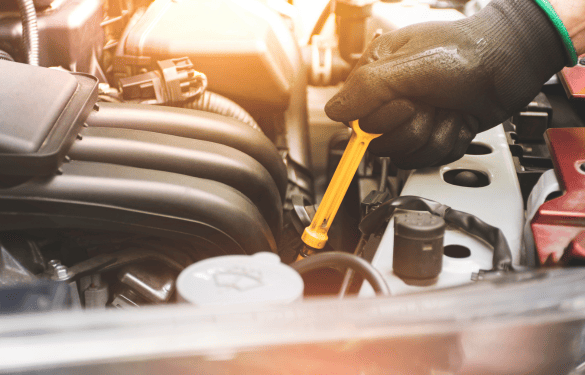 Skilled mechanic performing engine repair and maintenance on a vehicle.